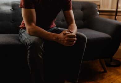man sitting on sofa